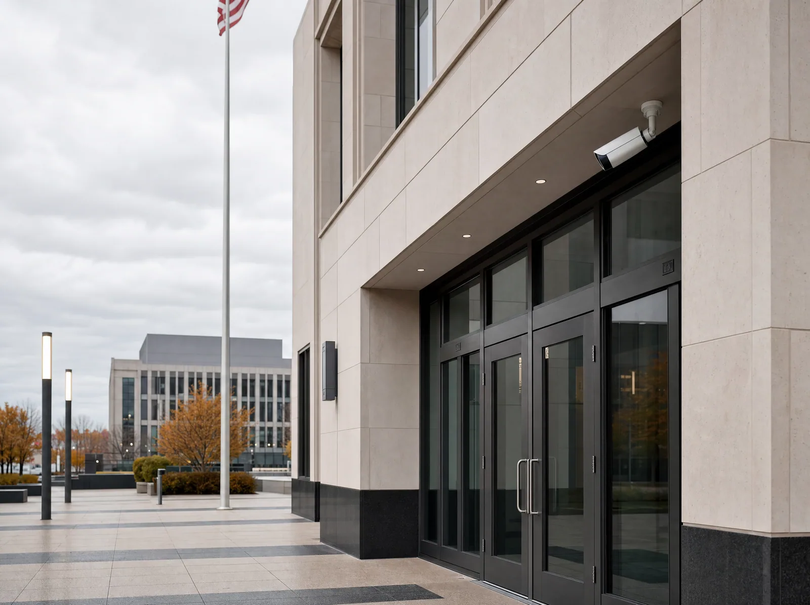 Modern city hall exterior with a security camera above the glass entrance